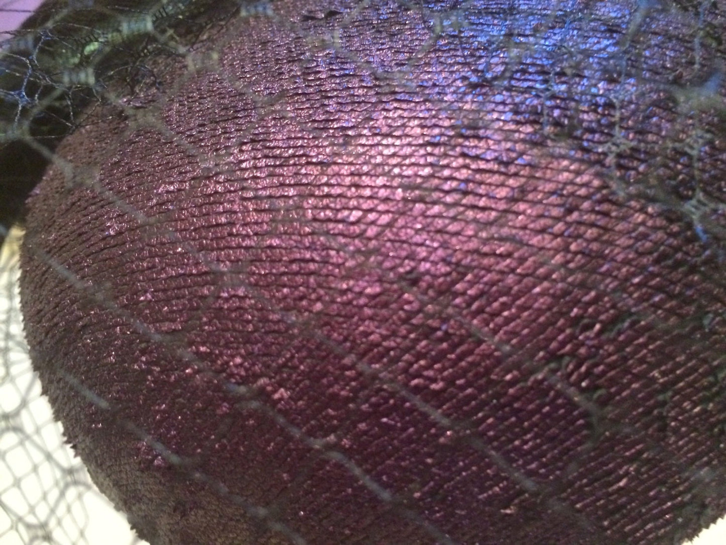 Aubergine Iridescent Leather pillbox. Perfect Ascot Derby Race Day. Hat with black crinoline, Black veiling and iridescent rooster feathers.