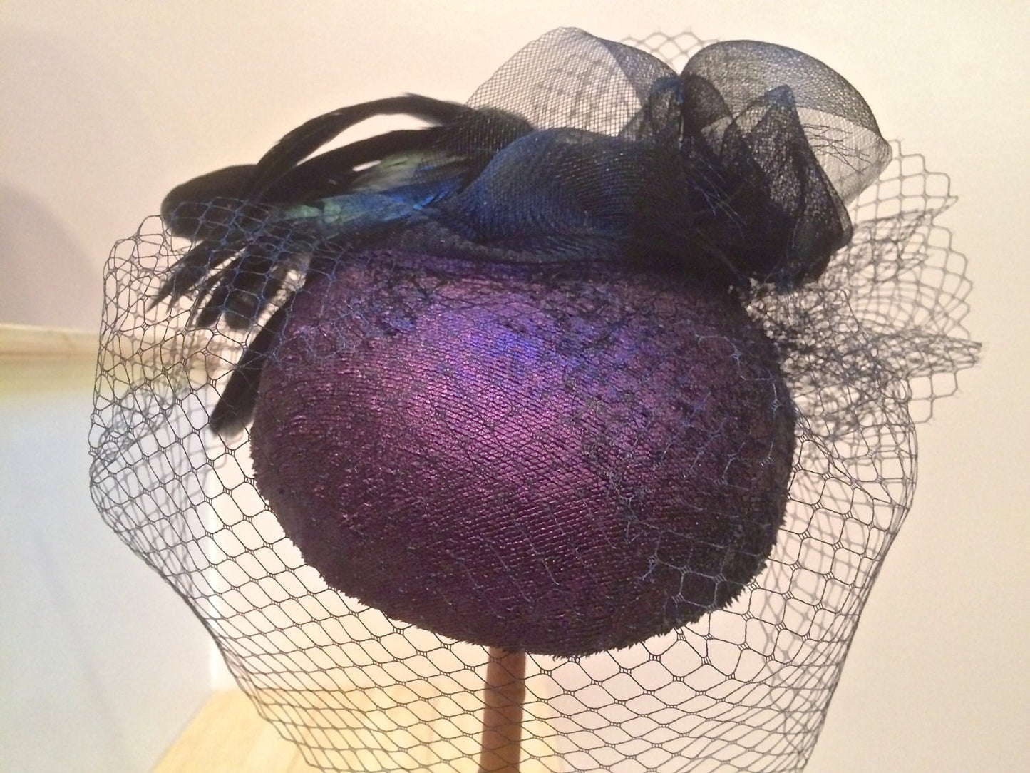 Aubergine Iridescent Leather pillbox. Perfect Ascot Derby Race Day. Hat with black crinoline, Black veiling and iridescent rooster feathers.