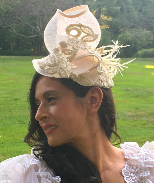 Ivory Embroidered Lace Fascinator with Gold Metallic threads and Pearls. Embellished with Feathers and Silk Trimmed Crinoline.